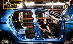 (FILES) This file photo taken on May 6, 2020 in Flins-sur-Seine, shows the assembly line that produces both the electric vehicle Renault Zoe and the hybrid vehicle Nissan Micra, the largest Renault production site in France. - France is preparing a package of measures to shore up automakers stung by the coronavirus crisis, including subsidies to encourage purchases of electric vehicles, Finance Minister Bruno Le Maire said May 18, 2020. (Photo by Martin BUREAU / AFP)