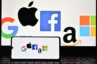 (FILES) In this file photo taken on December 18, 2020, an illustration picture taken in London shows the logos of Google, Apple, Facebook, Amazon and Microsoft displayed on a mobile phone and a laptop screen. - US lawmakers take a first step toward regulating Big Tech on June 23, 2021 with a vote on a series of bills with potentially massive implications for large online platforms and consumers who use them. (Photo by JUSTIN TALLIS / AFP)