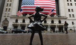 The Fearless Girl statue stands in front of the New York Stock Exchange near Wall Street on March 23, 2020 in New York City. - Wall Street fell early March 23, 2020 as Congress wrangled over a massive stimulus package while the Federal Reserve unveiled new emergency programs to boost the economy including with unlimited bond buying. About 45 minutes into trading, the Dow Jones Industrial Average was down 0.6 percent at 19,053.17, and the broad-based S&P 500 also fell 0.6 percent to 2,290.31 after regaining some ground lost just after the open. (Photo by Angela Weiss / AFP)