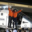 Pilots Andre Borschberg (L) and Bertrand Piccard celebrate after their arrival on Solar Impulse 2, a solar powered plane, at an airport in Abu Dhabi, United Arab Emirates July 26, 2016. REUTERS/Stringer 