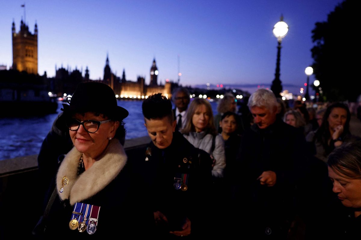 Members of the public stand in line as they queue to pay their respects to the late Queen Elizabeth II in London