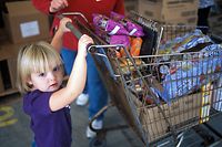 Emily Sayler, age 2, pushes a cart at the foodbank in McArthur, Ohio.
