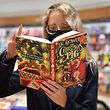 A member of staff holds a copy of JK Rowling's new children's novel "The Christmas Pig" at the Waterstones Piccadilly bookshop in London on October 12, 2021. (Photo by JUSTIN TALLIS / AFP)