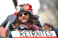 A man takes part in a demonstration by thousands of people in Nantes, western France, on January 16, 2020, as part of a nationwide multi-sector strike against the French government's pensions overhaul. - Unions have been waging a transport strike against the pension overhaul since December 5, 2019, the longest transport strike in France in decades. (Photo by Loic VENANCE / AFP)