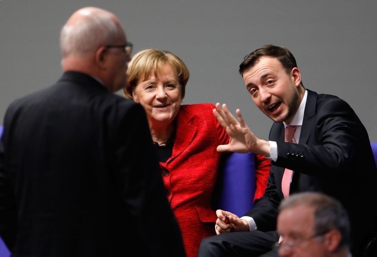 German Chancellor Angela Merkel talks with Paul Ziemiak (R), leader of her Christian Democratic Union (CDU) party's youth organisation Junge Union, and CDU/CSU parliamentary group leader Volker Kauder (L)
