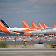 (FILES) In this file photo taken on July 14, 2020, parked aircrafts operated by Easyjet are pictured from the construction site of Berlin Brandenburg Airport (BER) Schoenefeld Airport near Berlin. - EasyJet expects a pre-tax loss of up to £845 million for its fiscal year just ended as coronavirus travel restrictions slam passenger demand, the British no-frills airline said Thursday. (Photo by Tobias SCHWARZ / AFP)