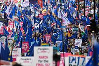 TOPSHOT - Demonstrators hold placards and EU and Union flags as they take part in a march by the People's Vote organisation in central London on October 19, 2019, calling for a final say in a second referendum on Brexit. - Thousands of people march to parliament calling for a "People's Vote", with an option to reverse Brexit as MPs hold a debate on Prime Minister Boris Johnson's Brexit deal. (Photo by Niklas HALLE'N / AFP)