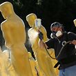 Stage craft artist Rick Roberts gives Oscar statues a fresh coat of gold paint as preparations begin for the 89th Academy Awards in Hollywood, California, U.S., February 22, 2017.     REUTERS/Mike Blake