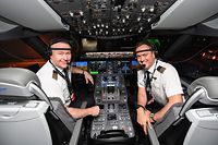 In this handout photo from Qantas taken on on October 18, 2019 shows Qantas pilots captain Sean Golding (L) and first officer Jeremy Sutherland in the cockpit of a Qantas Boeing 787 Dreamliner plane in New York before completing a non-stop test flight from New York to Sydney. - The Qantas Boeing 787 completed the flight, non-stop New York to Sydney in 19 hours and 15 minutes on October 20,  2019 (Photo by JAMES D. MORGAN / QANTAS / AFP) / --EDITORS NOTE -- RESTRICTED TO EDITORIAL USE MANDATORY CREDIT " AFP PHOTO / QANTAS " NO MARKETING NO ADVERTISING CAMPAIGNS - DISTRIBUTED AS A SERVICE TO CLIENTS - NO ARCHIVES