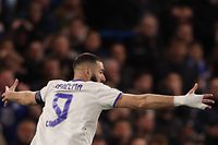 Real Madrid's French striker Karim Benzema celebrates after scoring his third goal during the UEFA Champions League Quarter-final first leg football match between Chelsea and Real Madrid at Stamford Bridge stadium in London, on April 6, 2022. (Photo by Adrian DENNIS / AFP)