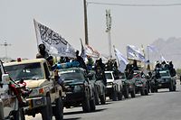 TOPSHOT - Taliban fighters atop vehicles with Taliban flags parade along a road to celebrate after the US pulled all its troops out of Afghanistan, in Kandahar on September 1, 2021 following the Taliban�s military takeover of the country. (Photo by JAVED TANVEER / AFP)