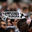 People gather at the Puerta del Sol square in Madrid on May 27, 2018 to watch Real Madrid�s football players parade on an open-top bus after winning their third Champions League title in a row in Kiev. / AFP PHOTO / OSCAR DEL POZO