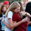 (FILES) In this file photo taken on February 15, 2018 Mourners grieve as they await the start of  a candlelight vigil for victims of the Marjory Stoneman Douglas High School shooting in Parkland, Florida. 
There have been renewed calls for stricter gun control in the United States following the shooting deaths last week of 14 students and three adults at a Florida high school. The White House has said following the Florida school shooting that President Donald Trump supports efforts to improve the federal background check system for gun buyers. / AFP PHOTO / RHONA WISE