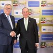 European commission president Jean-Claude Juncker (L) shakes hands with united nations secretary-general envoy for climate action Michael Bloomberg during the green finance conference at the European commission headquarters on March 22, 2018, in Brussels. / AFP PHOTO / Ludovic MARIN
