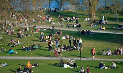 People enjoy warm and spring-like weather with high temperatures on April 22, 2020, in Stockholm. - Sweden has not imposed the extraordinary lockdown measures seen across Europe, instead urging people to take responsibility and follow official recommendations. Gatherings of more than 50 people have been barred along with visits to nursing homes. (Photo by Anders WIKLUND / TT NEWS AGENCY / AFP) / Sweden OUT