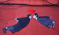 A street art sticker depicting a couple kissing while wearing face masks is pictured in Madrid on April 26, 2020 during a national lockdown to prevent the spread of the COVID-19 disease. - Spain's daily coronavirus death toll dropped to 288 on April 26, 2020, the lowest since March 20, as the country eased its lockdown to allow children outside for the first time in six weeks. The health ministry said the figure dropped from 378 on April 25, 2020 and brought Spain's total toll to 23,190, the third highest number of deaths after the United States and Italy. The news came as the country took the first steps to ease one of the world's toughest lockdowns. (Photo by Gabriel BOUYS / AFP)