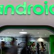 Visitors walk past the Android stand at the Mobile World Congress in Barcelona on 25 February 2019