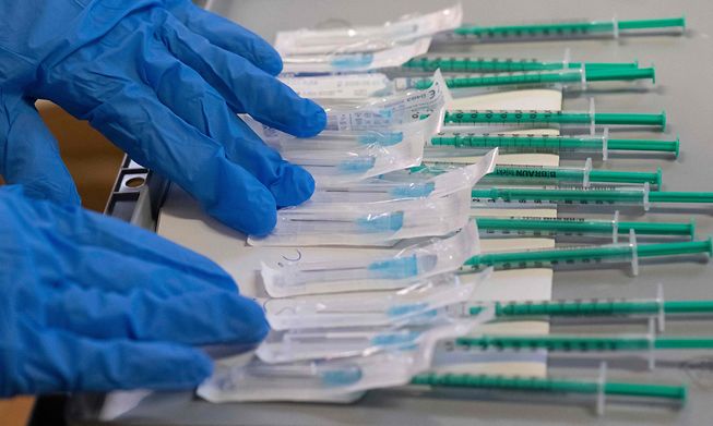 Syringes filled with the BioNtech-Pfizer Covid-19 coronavirus vaccine are being prepared in a mobile vaccination center in Hemmingen, Germany, on Tuesday