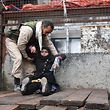 A wounded Syrian woman from the al-Sukari neighbourhood is helped onto the back of a truck as she flees during the ongoing government forces military operation to retake remaining rebel-held areas in the northern embattled city of Aleppo on December 14, 2016. 
Shelling and air strikes sent terrified residents running through the streets of Aleppo as a deal to evacuate rebel districts of the city was in danger of falling apart.

 / AFP PHOTO / George OURFALIAN