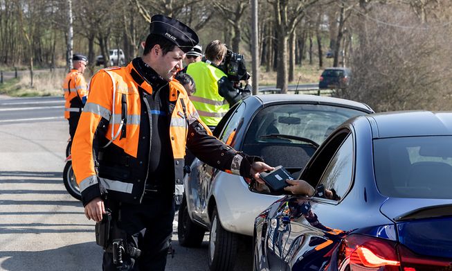 A police officer checking a driver's documents
