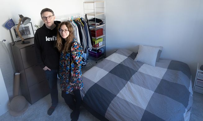 Benjamin Cler and Corina Darii stand in the spare bedroom they have prepared to welcome Ukrainian refugees