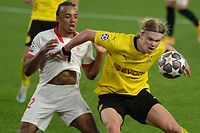 Dortmund's Norwegian forward Erling Braut Haaland (R) challenges Sevilla's French defender Jules Kounde during the UEFA Champions League round of 16 first leg football match between Sevilla FC and Borussia Dortmund at the Ramon Sanchez Pizjuan stadium in Seville on February 17, 2021. (Photo by CRISTINA QUICLER / AFP)
