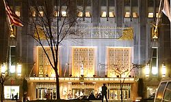 A  police office is silhouetted against the brightly lit main entrance of the Waldorf Astoria Hotel in New York, Thursday, Jan. 31, 2002 where the World Economic Forum is being held. Some 4,000 police were assigned to forum security, with many concentrated around the conference site. (AP Photo/Ron Frehm)