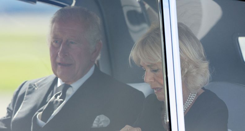Britain's King Charles III (L) and Britain's Camilla, Queen Consort are driven away from Edinburgh airport on September 12, 2022, to attend the service of Thanksgiving for the life of Queen Elizabeth II at St Giles' Cathedral. - King Charles III made his first address to the British parliament on Monday before heading to Scotland, where he will walk in procession with other senior royals behind his mother's coffin from the Palace of Holyroodhouse, where it rested overnight, to St Giles' Cathedral. In the evening, the monarch will lead a family vigil at the 12-century cathedral. The public will also be able to pay their respects there before the coffin is flown to London ahead of the funeral on September 19. (Photo by Robert Perry / POOL / AFP)