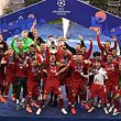 Liverpool's players celebrate with the trophy after winning the UEFA Champions League final football match between Liverpool and Tottenham Hotspur at the Wanda Metropolitan Stadium in Madrid on June 1, 2019. (Photo by ANTONIN THUILLIER / AFP)