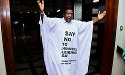 Member of Parliament from Bubulo contituency John Musira dressed in an anti gay gown gestures as he leaves the chambers during the debate of the Anti-Homosexuality bill, which proposes tough new penalties for same-sex relations during a sitting at the Parliament buildings in Kampala, Uganda March 21, 2023. REUTERS/Abubaker Lubowa