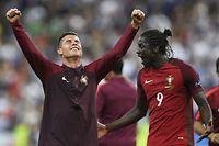 Portugal's forward Eder (R) and Portugal's forward Cristiano Ronaldo react after Portugal beat their hosts France 1-0 in the Euro 2016 final football match between France and Portugal at the Stade de France in Saint-Denis, north of Paris, on July 10, 2016. / AFP PHOTO / MARTIN BUREAU