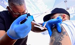 Nurse Eon Walk administers the Pfizer Covid-19 vaccine at a mobile vaccine clinic hosted by Mothers in Action and operated by the Los Angeles County of Public Health on July 16, 2021 in Los Angeles, California. - Covid-19 cases across America are rising in all 50 states as the Delta variant spreads with half the US population yet to be fully vaccinated. (Photo by Frederic J. BROWN / AFP)