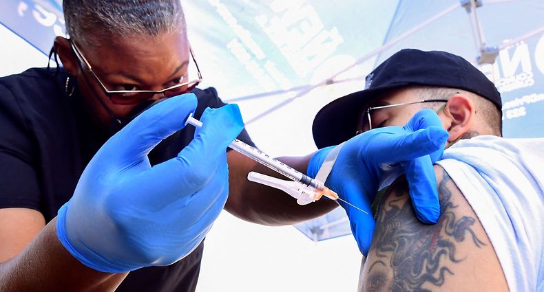 Nurse Eon Walk administers the Pfizer Covid-19 vaccine at a mobile vaccine clinic hosted by Mothers in Action and operated by the Los Angeles County of Public Health on July 16, 2021 in Los Angeles, California. - Covid-19 cases across America are rising in all 50 states as the Delta variant spreads with half the US population yet to be fully vaccinated. (Photo by Frederic J. BROWN / AFP)