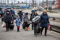 Refugees - including from Kryvyi Rih, where ArcelorMittal has a huge factory - disembark from a train at the Lviv station in April