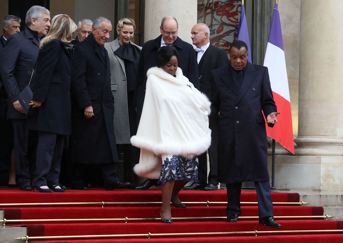 Republic of the Congo's President Denis Sassou Nguesso (R) and his wife Antoinette Sassou Nguesso leave the Elysee Palace in Paris on November 11, 2018 for the Arc de Triomphe prior to the start of commemorations marking the 100th anniversary of the 11 November 1918 armistice, ending World War I. (Photo by JACQUES DEMARTHON / AFP)