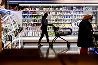 (FILES) This file photo taken on April 29, 2020 shows a customer pushing a shopping cart past the shelves during  purchases at a supermarket in Duesseldorf, western Germany, on April 29, 2020. - A surge in eurozone consumer prices, propelled even higher by Russia's invasion of Ukraine, is "very close" to reaching its peak, European Central Bank vice-president Luis de Guindos said on April 28, 2022. (Photo by Ina FASSBENDER / AFP)