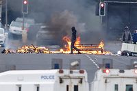 TOPSHOT - Loyalists block a road with burning debris on Lanark Way in West Belfast on April 19, 2021 as disturbances within the loyalist communities of northern Ireland resumed after a pause for the funeral of Prince Philip, Duke of Edinburgh. - Northern Ireland is witnessing its worst unrest of recent years stemming mainly from its unionist community who are angry over apparent economic dislocation due to Brexit and existing tensions with pro-Irish nationalist communities. (Photo by Paul Faith / AFP)