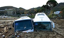 TOPSHOT - Damaged tourist busess are seen on the port of Casamicciola on November 27, 2022, following heavy rains that caused a landslide on the island of Ischia, southern Italy. - Italian rescuers were searching for a dozen missing people on the southern island of Ischia after a landslide killed at least one person, as the government scheduled an emergency meeting. A wave of mud and debris swept through the small town of Casamicciola Terme early Saturday morning, engulfing at least one house and sweeping cars down to the sea, local media and emergency services said. (Photo by Eliano IMPERATO / AFP)