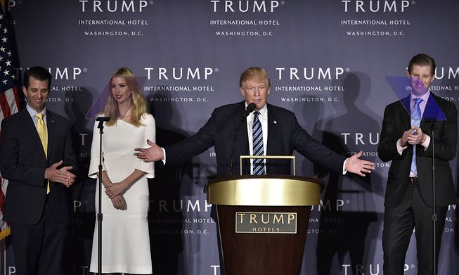 Republican presidential nominee Donald Trump, with children (L-R) Donald Trump Jr., Ivanka Trump, and Eric Trump, during the grand opening of the Trump International Hotel 26 October, 2016, Washington, DC