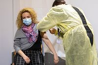A woman receiving a Covid-19 vaccine at a centre in Luxembourg last year