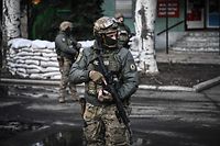 Ukrainian troops patrol in the town of Novoluhanske, eastern Ukraine, on February 19, 2022. - Ukraine's army said Saturday that two of its soldiers died in attacks in on the frontline with Russian-backed separatists, the first fatalities in the conflict in more than a month. "As a result of a shelling attack, two Ukrainian servicemen received fatal shrapnel wounds," the military command for the separatist conflict said. (Photo by ARIS MESSINIS / AFP)