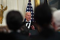 US President Joe Biden (R) speaks as he hosts the Kennedy Center Honorees Reception in the East Room of the White House in Washington, DC, on December 5, 2021. (Photo by Nicholas Kamm / AFP)