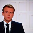France's President Emmanuel Macron appears on a TV screen as he addresses to the nation on Covid-19 and reforms in Paris on November 9, 2021. - For the ninth time since the beginning of the Covid-19 crisis, Emmanuel Macron solemnly addresses the French to boost the vaccine recall in the face of the rebound of the epidemic, to boast of his record and to evoke the priorities of the end of the five-year term. (Photo by Christophe ARCHAMBAULT / AFP)