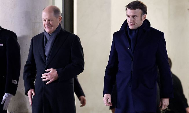 French President Emmanuel Macron and German Chancellor Olaf Scholz leave the Elysee Palace on Sunday