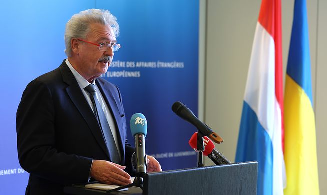 Luxembourg's Foreign and Immigration Minister Jean Asselborn at a press conference on Monday in front of Luxembourgish and Ukrainian flags