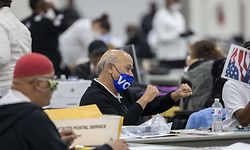 DETROIT, MI - NOVEMBER 04: A worker with the Detroit Department of Elections celebrates after hearing the nearly final number of 167,000 absentee ballots that were counted is announced over the loudspeaker at the Central Counting Board in the TCF Center on November 4, 2020 in Detroit, Michigan. President Trump narrowly won Michigan in 2016, and both he and Joe Biden campaigned heavily in the battleground state in 2020.   Elaine Cromie/Getty Images/AFP
== FOR NEWSPAPERS, INTERNET, TELCOS & TELEVISION USE ONLY ==
