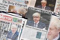 Front pages of British national newspapers, each leading with a front page story of the resignation of Boris Johnson as leader of Britain's Conservative Party, are arranged for a photograph in Downing Street, the official residence of Britain's Prime Minister, in central London on July 8, 2022. - UK Prime Minister Boris Johnson on Thursday quit as Conservative party leader, after three tumultuous years in charge marked by Brexit, Covid and mounting scandals. Johnson, 58, announced that he would step down after a slew of resignations this week from his top team in protest at his leadership but would stay on as prime minister until a replacement is found. (Photo by CARLOS JASSO / AFP)