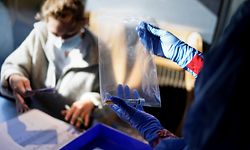 Members of a medical team working in a Saint Pierre Hospital bus parked in front of a retirement home, conduct test for the COVID-19 on the staff workers of the elderly residence, in Brussels, on April 22, 2020 during a strict lockdown in the country aimed at curbing the spread of the novel coronavirus. (Photo by Kenzo TRIBOUILLARD / AFP)