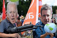 Protesters wearing masks of US President Joe Biden (L) and French President Emmanuel Macron take part in a demonstration called for by Greenpeace, Attac and other organisations ahead of the G7 Summit at the Theresienwiese in Munich, southern Germany on June 25, 2022. (Photo by KERSTIN JOENSSON / AFP)