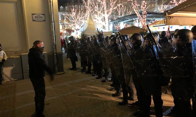 Police forming a shield at the Place d'Armes on Saturday evening